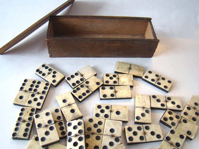 An outstanding set of hand cut Civil War era bone & ebony dominoes in their original box circa 1860